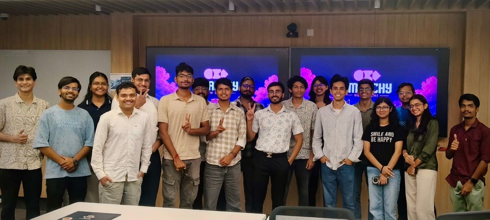 Group photo of attendees at Omarchy New Delhi in front of the Omarchy screens