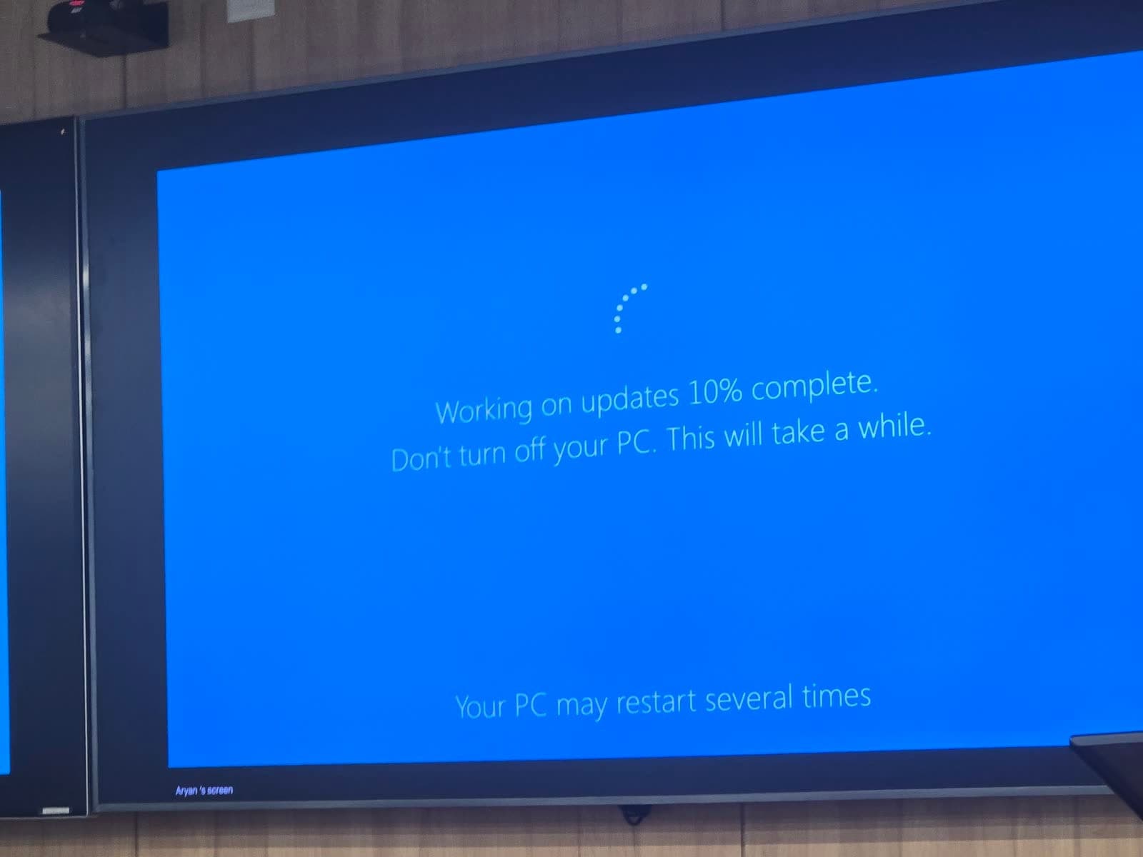 A Windows 'Working on updates' screen projected as a slide